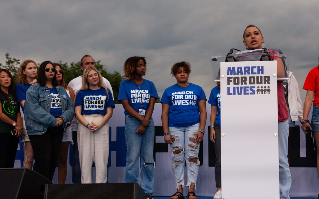 Survivors of gun violence stand on stage as X Gonzalez speaks during the flagship March for Our Lives protest against gun violence in Washington, DC. Thousands of protesters in Washington demanded that elected officials take action to reduce gun violence.