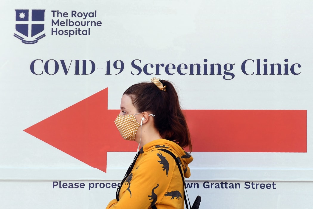 A woman queues outside a Covid-19 coronavirus testing venue at The Royal Melbourne Hospital in Melbourne on July 16, 2020.
