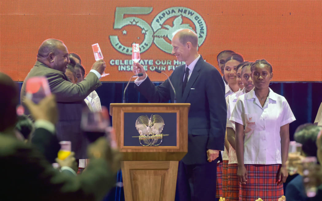 Papua New Guinea's Prime Minister James Marape (L) and Britain's Prince Edward, Duke of Edinburgh (C) raise a toast during a dinner on the eve of Papua New Guinea's 50th independence anniversary, in Port Moresby on September 15, 2025.  (Photo by Andrew KUTAN / AFP)