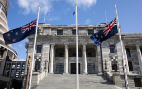 Flags at half mast in front of Parliament