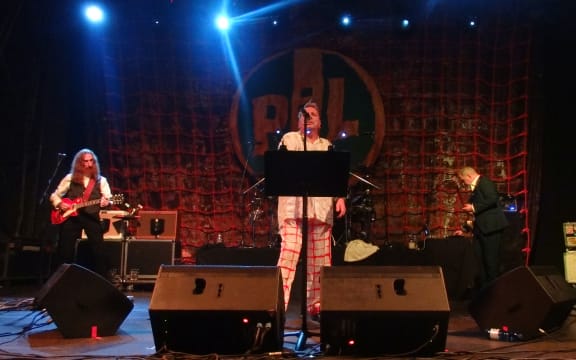 Public Image Ltd. on stage performing in 2013.