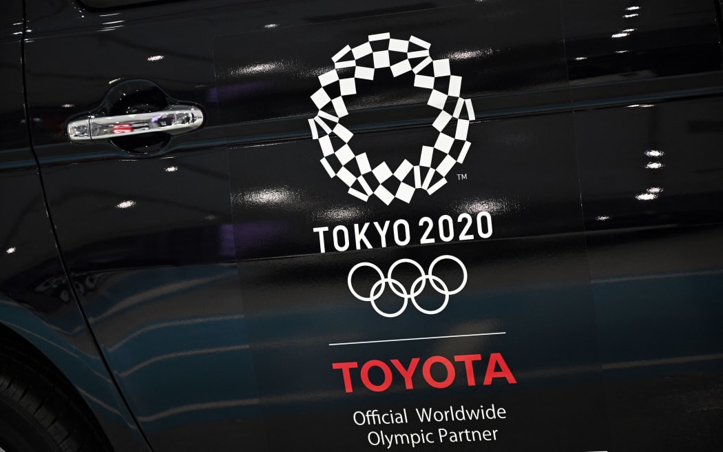 An Olympics games logo is seen on a displayed car at Toyota showroom in Tokyo on 6 November 2020.