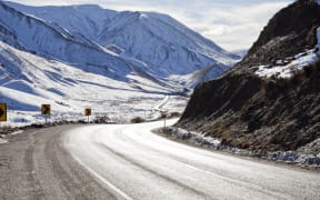 Road winding through a snow covered Lewis Pass, Canterbury, South Island, New Zealand