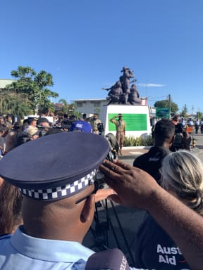 A Solomon Islands police officer salutes the Coastwatchers Monument at Point Cruz in Honiara during the 80th anniversary of the WWII Battle of Guadalcanal.