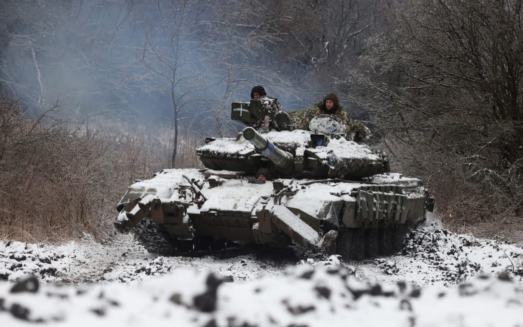 Ukrainian soldiers drive a tank in a position near to the town of Bakhmut, Donetsk region, on December 13, 2023.