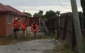 Volunteers (L-R) Daryl Johnson, Deborah Waddingham and Shari Walker search the red zone in Christchurch's Bexley.