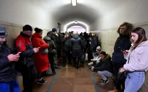 Residents take shelter in a metro station during an air strike alarm on the eve of Orthodox Christmas, in the Ukrainian capital of Kyiv on January 6, 2022, amid the Russian invasion of Ukraine. - A temporary unilateral Russian ceasefire ordered by Russian President during Orthodox Christmas was due to have taken effect in Ukraine at 0900 GMT on January 6, 2023. Dismissed by Ukraine as an empty gesture and an attempt by Moscow to gain time to regroup its forces, the ceasefire is due to last until 2100 GMT on January 7, 2023.
