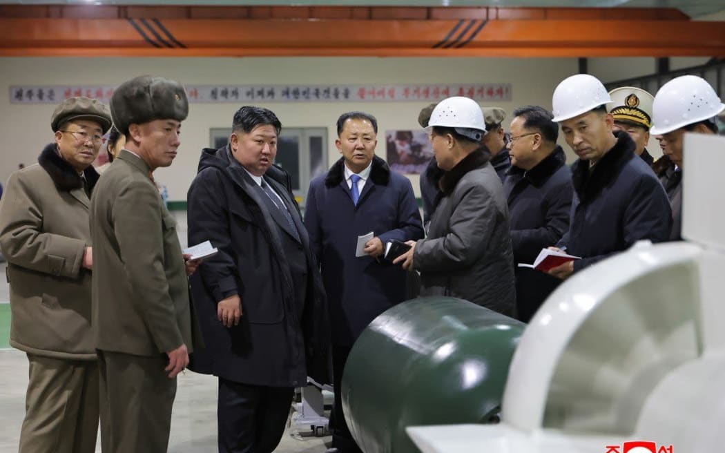 North Korea's leader Kim Jong Un is briefed on the construction of the country's first nuclear-powered submarine.