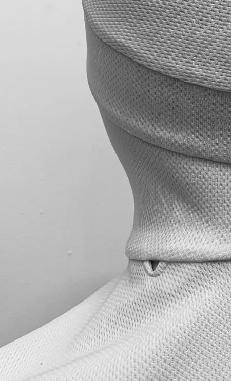 A view of the back of the New Zealand Police hijab, with detail showing space for communication device connection.