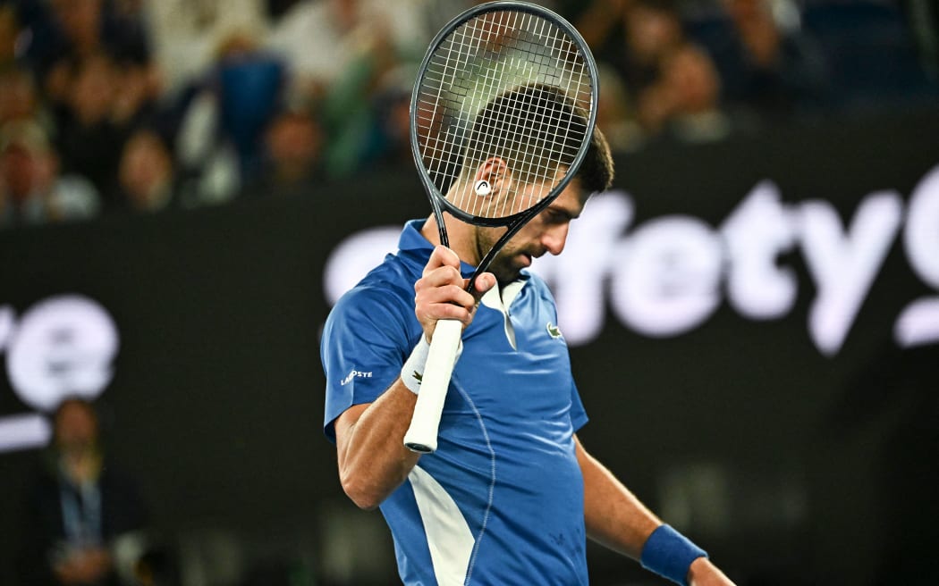 Serbia's Novak Djokovic reacts on a point against Australia's Alexei Popyrin during their men's singles match on day four of the Australian Open tennis tournament in Melbourne on January 17, 2024. (Photo by Lillian SUWANRUMPHA / AFP) / -- IMAGE RESTRICTED TO EDITORIAL USE - STRICTLY NO COMMERCIAL USE --