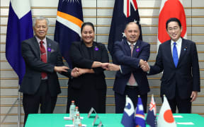 From left: Pacific Islands Forum Secretary General Henry Puna, Marshall Islands Foreign Minister and chief negotiator Kitlang Kabua, Prime Minister of the Cook Islands Mark Brown, and Japanese Prime Minister Fumio Kishida at a meeting of Pacific Island Forum in Tokyo