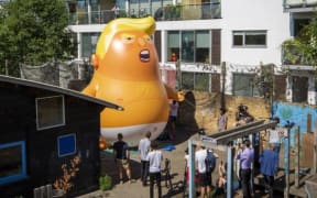 Campaigners tried out the inflatable baby at Martin Luther King adventure playground in Islington.