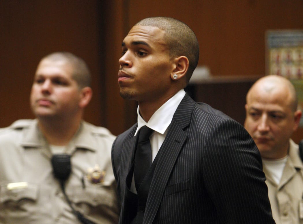A file photo taken on 25 August 2009 shows Chris Brown, centre, inside the Los Angeles Superior Court during his sentencing for assault against Rihanna.