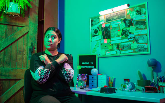 Bubbah sits in a green room referencing Black Panther