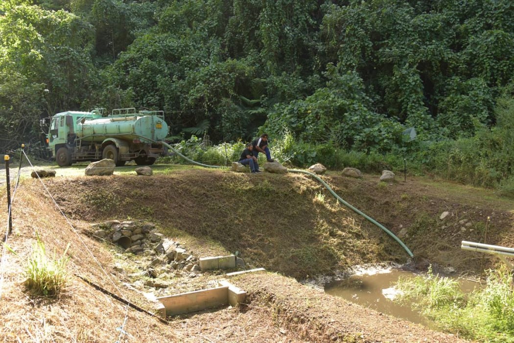 Truck moving sludge from Rarotonga water treatment site to dump at Papua
