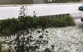 Hail covers the road on a Timaru street.