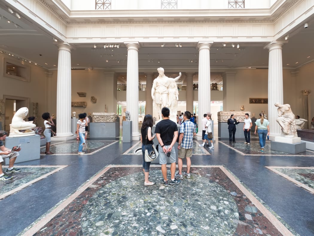 NEW YORK,USA - AUGUST 14,2015 : Visitors admiring ancient greek and roman art at the Metropolitan Museum of Art in Manhattan