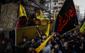 The coffins of Ibrahim Aqil, the Hezbollah Radwan Forces commander, and Mahmoud Hamad, another Hezbollah commander, both killed in an Israeli airstrike on a residential building are driven through the streets of the southern suburb of Dahiyeh in Beirut, Lebanon. (Photo by Oliver Marsden / Middle East Images / Middle East Images via AFP)