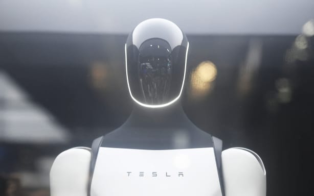 Visitors visit Tesla's humanoid robot "Optimus" at the 2025 World Artificial Intelligence Conference in Shanghai, China on July 28, 2025.