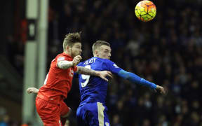 Liverpool's Spanish defender Alberto Moreno (L) vies with Leicester's English striker Jamie Vardy