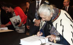 Negotiator Pauline Tongiaroa initals the Deed of Settlement (far right).