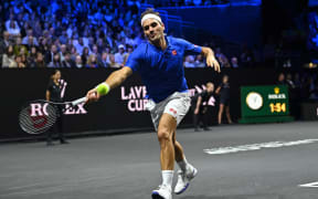 Switzerland's Roger Federer playing with Spain's Rafael Nadal of Team Europe returns against USA's Jack Sock and USA's Frances Tiafoe of Team World during their 2022 Laver Cup men's doubles tennis match at the O2 Arena in London, early on September 24, 2022.