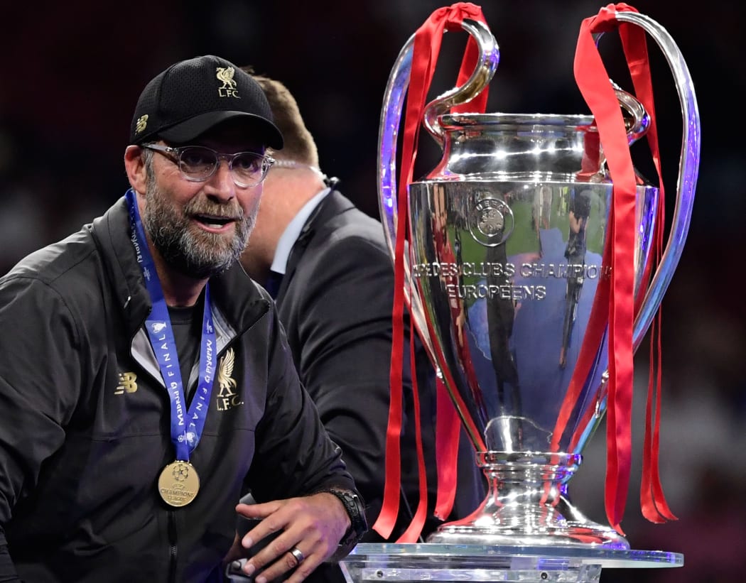Liverpool's German manager Jurgen Klopp looks at the trophy after winning the UEFA Champions League final football match between Liverpool and Tottenham Hotspur  in Madrid