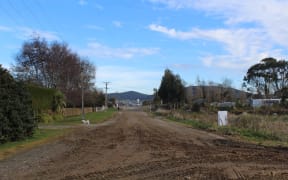 Boniface says her street is dusty in the summer and muddy in the winter.