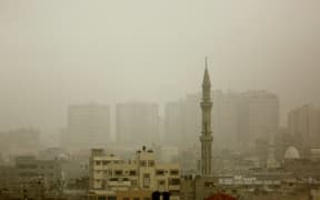 Gaza City's skyline is seen engulfed in dust as a storm hits the region.