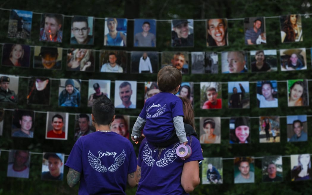 People look at photos of those lost to drug overdoses as many Edmontonians gathered at Victoria Park this evening to mark the annual International Overdose Awareness Day, on 31 August, 2023, in Edmonton, Alberta, Canada.