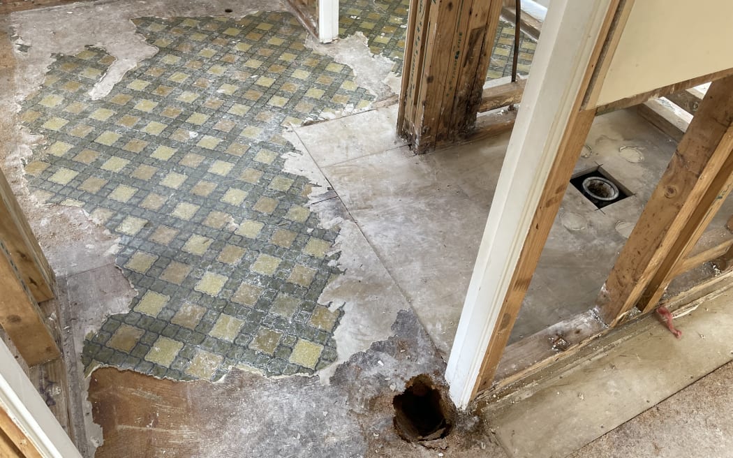 Inside Izma Azad's yellow-stickered West Auckland home, damaged by flooding in January.