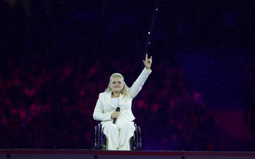 Ali Stroker gestures after she performed the National Anthem of the United States of America on stage during the Paris 2024 Paralympic Games Closing Ceremony at the Stade de France, in Saint-Denis, in the outskirts of Paris, on September 8, 2024. (Photo by Thibaud Moritz / AFP)