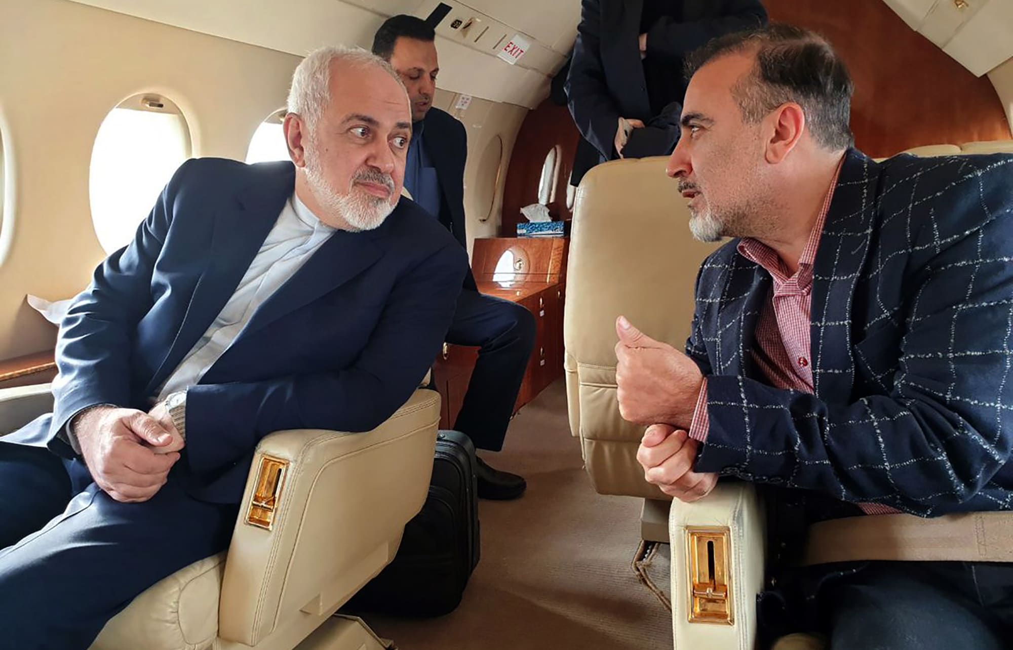 Foreign Minister Mohammad Javad Zarif (L) and Iranian scientist Massoud Soleimani speaking to each other while sitting in a plane at an undisclosed location.