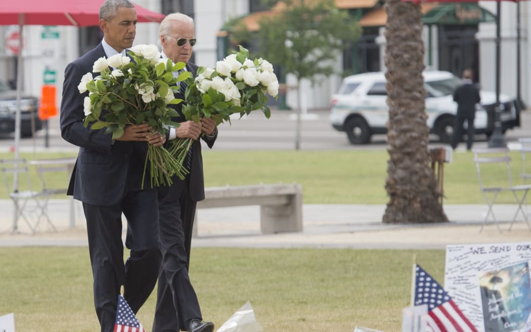 US President Barack Obama and Vice President Joe Biden place flowers for the victims of the mass shooting at a gay nightclub in Orlando.