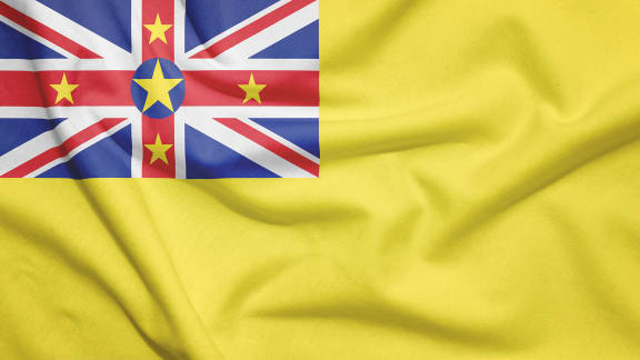 Niue flag on the fabric texture