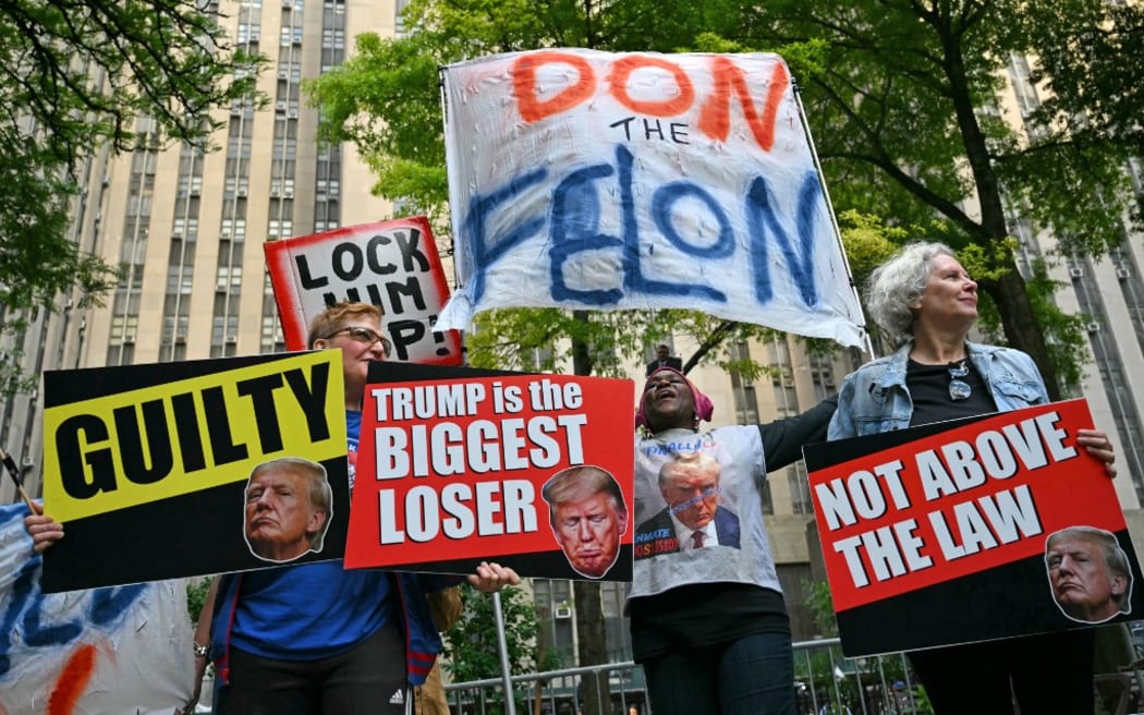 People react after former US President and Republican presidential candidate Donald Trump was convicted in his criminal trial outside of Manhattan Criminal Court in New York City, on May 30, 2024. A panel of 12 New Yorkers were unanimous in their determination that Donald Trump is guilty as charged -- but for the impact on his election prospects, the jury is still out. The Republican billionaire was convicted of all 34 charges in New York on May 30, 2024, and now finds himself bidding for a second presidential term unsure if he'll be spending 2025 in the Oval Office, on probation or in jail. (Photo by ANGELA WEISS / AFP)