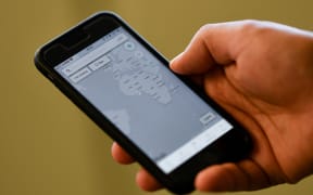 A person checks the "MyShake" app on their smartphone in Hollywood on 17 October, 2019. California launched the country's first earthquake warning system in the hope that residents will be alerted within seconds of a possible impending disaster and can  "drop, cover and hold on."