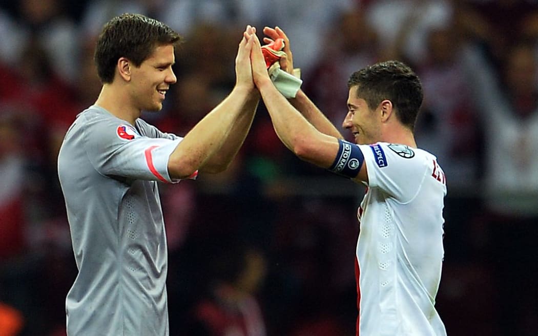 Poland's goalkeeper Wojciech Szczesny and captain Robert Lewandowski celebrate