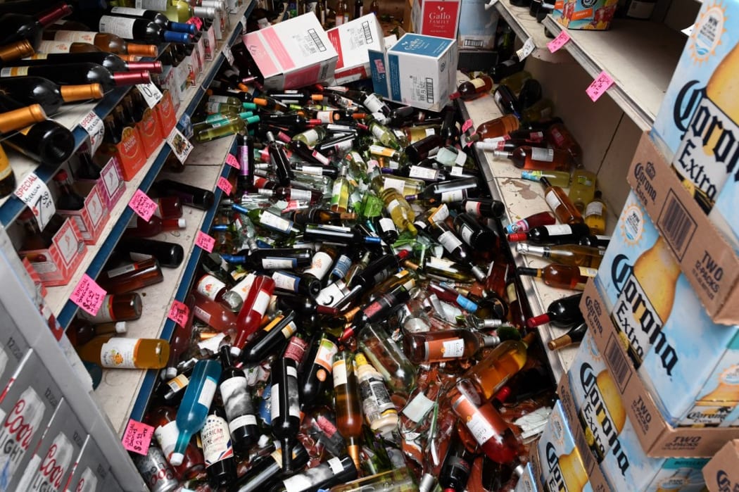 Broken bottles cover the floor of a liquor store in Ridgecrest, California, on July 6, 2019 following an earthquake on July 5, 2019.