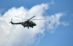 A Russian Mi-8 military transport helicopter flies during a rehearsal for the Navy Day parade in St. Petersburg, Russia. Alexei Danichev / Sputnik
