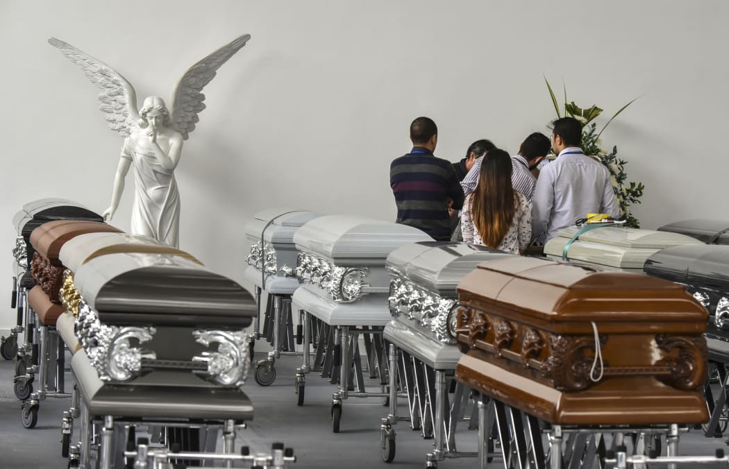 Executives of Chapecoense Real gather around the coffin of one of the team's players killed in plane crash in Colombia.