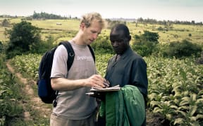 Jake Harriman talking with Agriculture Program Field Manager James Magaigwa Chacha in Kenya