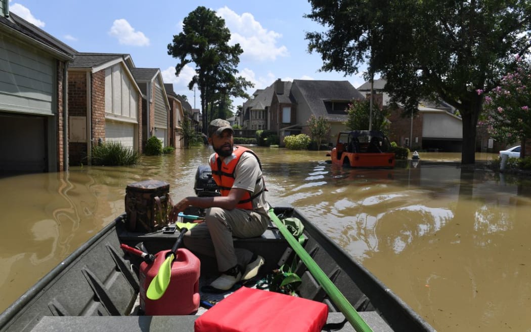 Volunteer rescuer Matt Clarke searches for local residents after a mandatory evacuation was ordered in the area beneath the Barker Reservoir.
