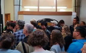 Dozens packed a small corridor outside the Dean of the Creative Arts and Industries department on 21 June to protest against the closure of three specialist libraries on University of Auckland's campus.