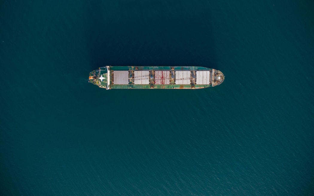 large bulk carrier transports grain at sea, aerial view