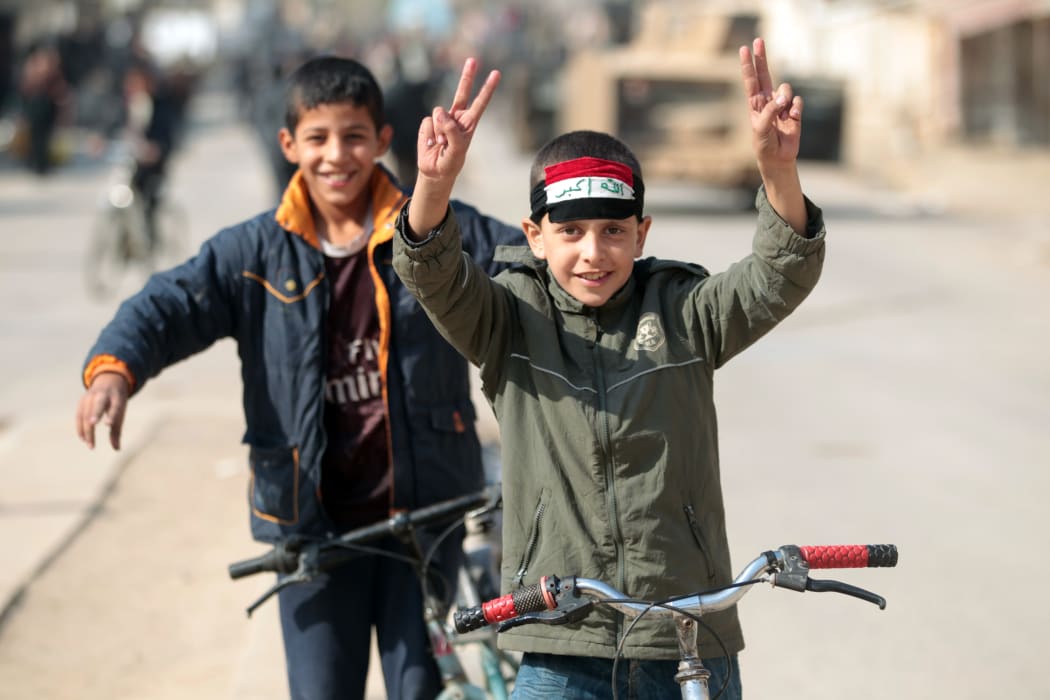 Boys from Hammam al-Alil celebrate as they return home after Iraqi forces re-took the town south of Mosul from Islamic State fighters.