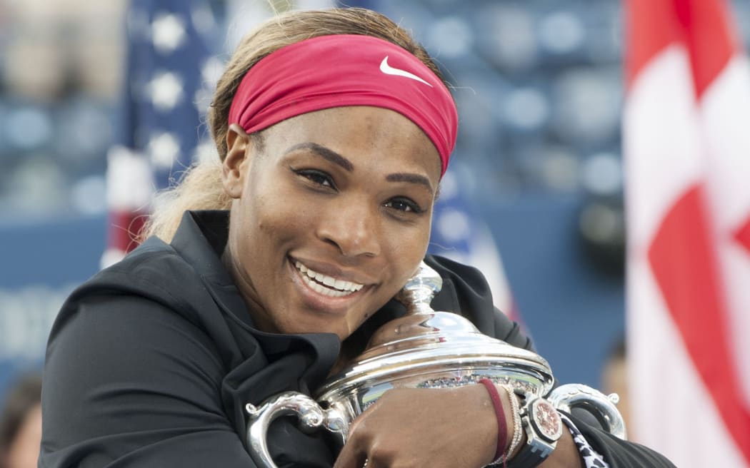 Serena Williams embraces the trophy.