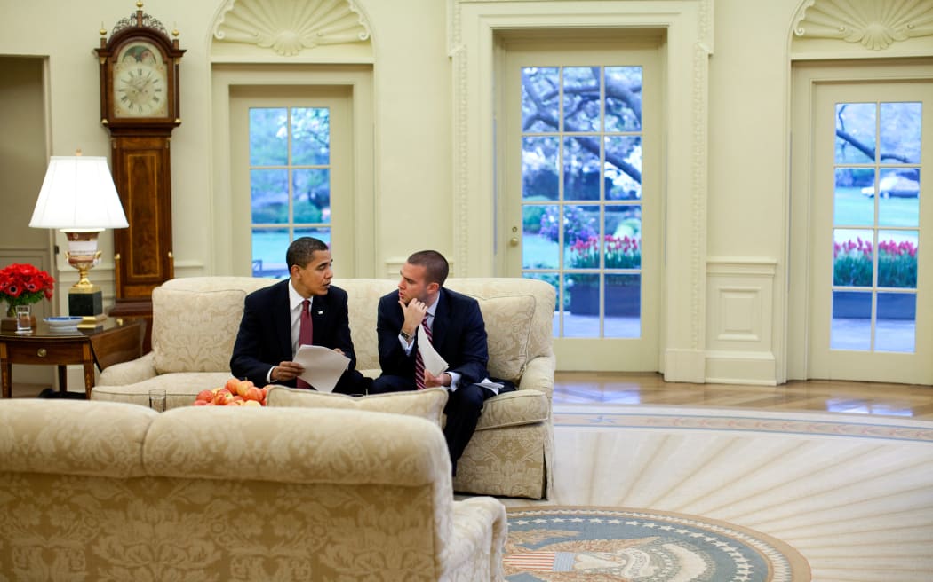 This White House handout photo shows US President Barack Obama meeting with Director of Speechwriting Jon Favreau in the Oval Office of the White House to review a speech, on April 14, 2009. Official White House Photo by Pete Souza (Photo by Pete SOUZA / WHITE HOUSE / AFP)