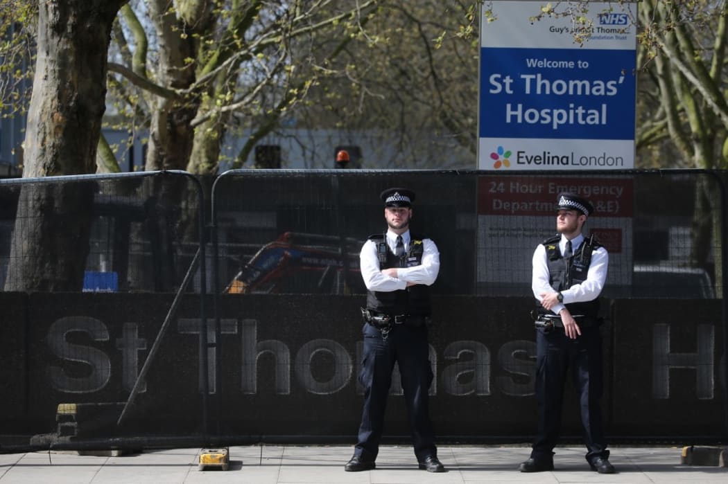 Police officers stand on duty outside St Thomas' Hospital in central London on April 7, 2020. where Britain's Prime Minister Boris Johnson is in intensive care.