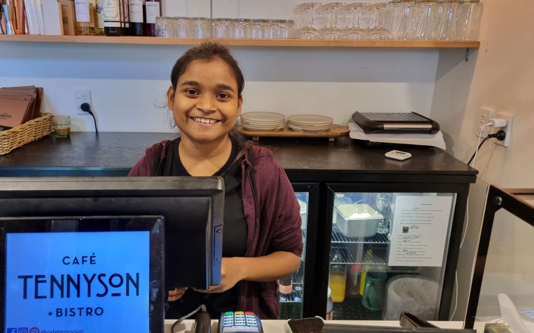 Tennyson's Cafe and Bistro duty manager Mohitha Vishwanath stands at the till of the cafe.